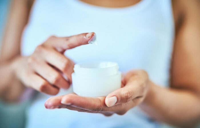 Cropped shot of an unrecognizable woman using a skincare product